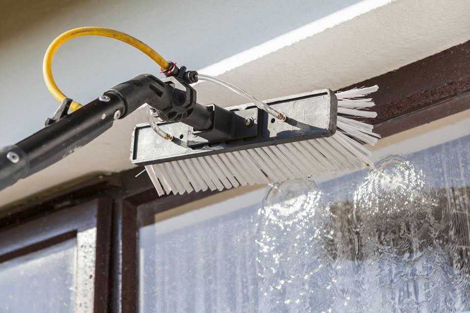 Professional window cleaning service in Clarksville, TN, removing dirt and streaks from a home’s windows.